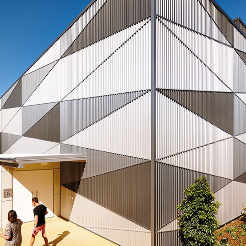 The harlequin-patterned facade of the auditorium disguises the scale of the theatre and animates the public domain